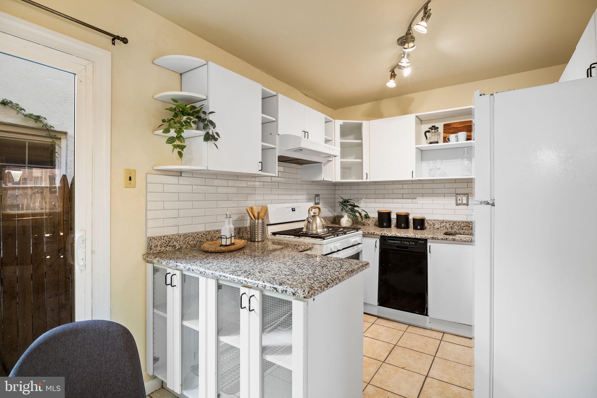 1905 Rodman Street Philadelphia, PA 19146 - Photo 9 of 22 a kitchen with stainless steel appliances granite countertop a stove sink and cabinets