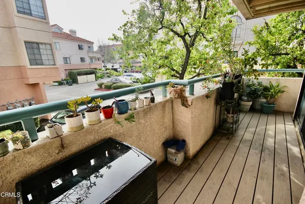 a view of balcony with wooden floor