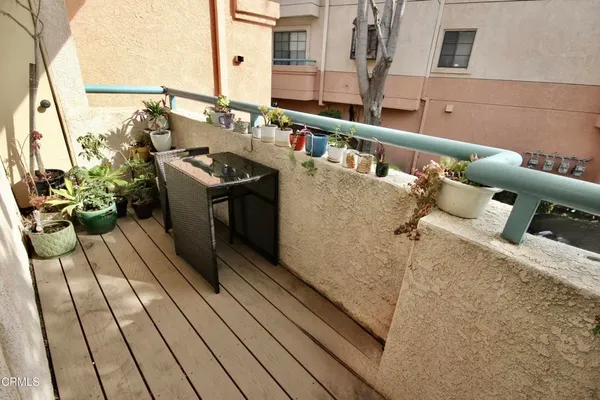 a view of balcony with wooden floor
