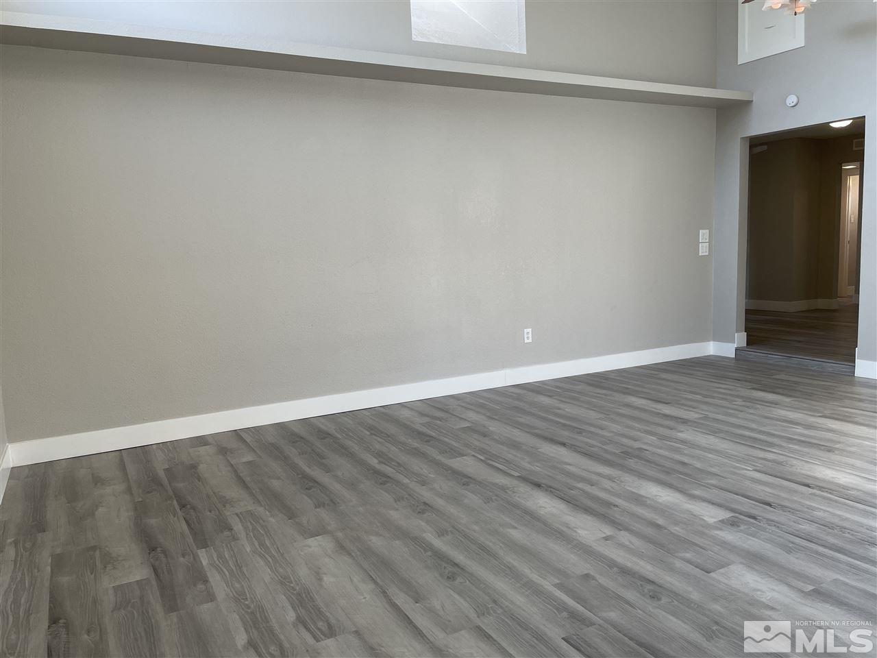 1440 Upton Way Sparks, NV 89431 - Photo 13 of 28 a view of an empty room with wooden floor
