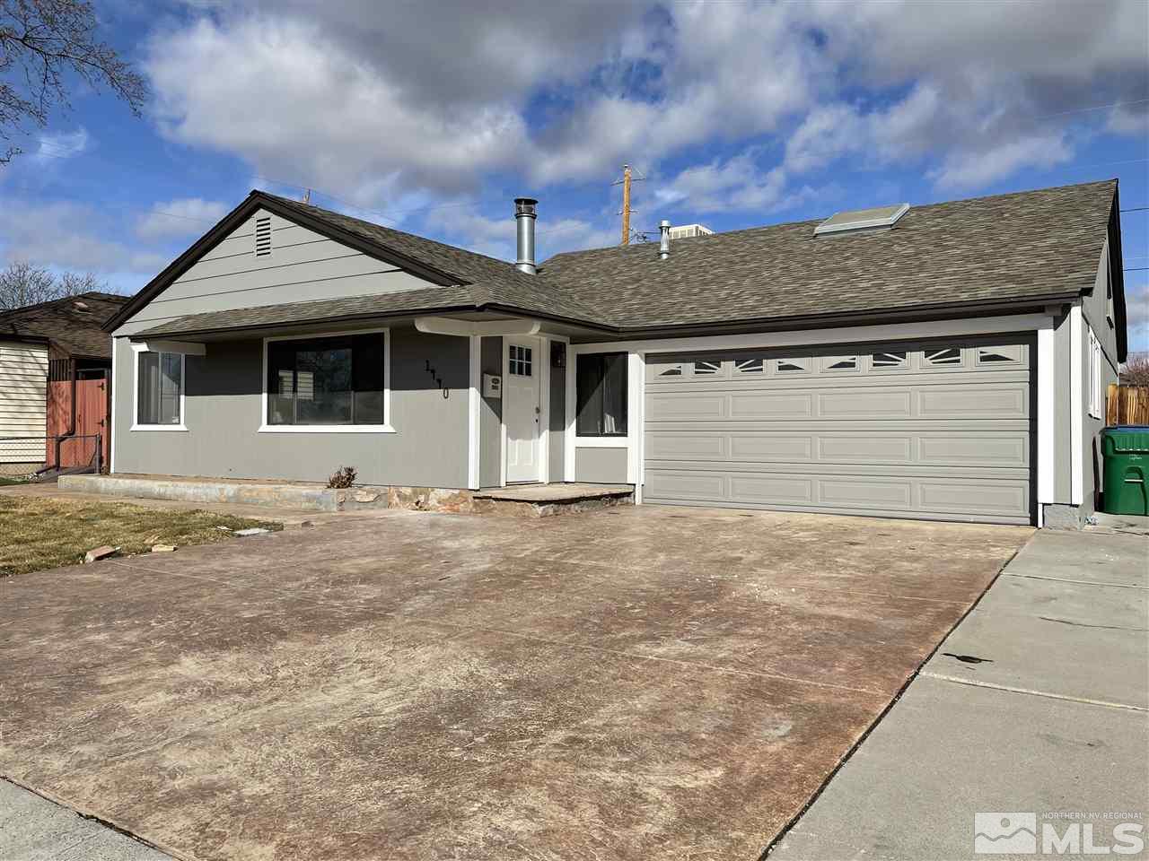 1440 Upton Way Sparks, NV 89431 - Photo 26 of 28 a front view of a house with a yard and garage