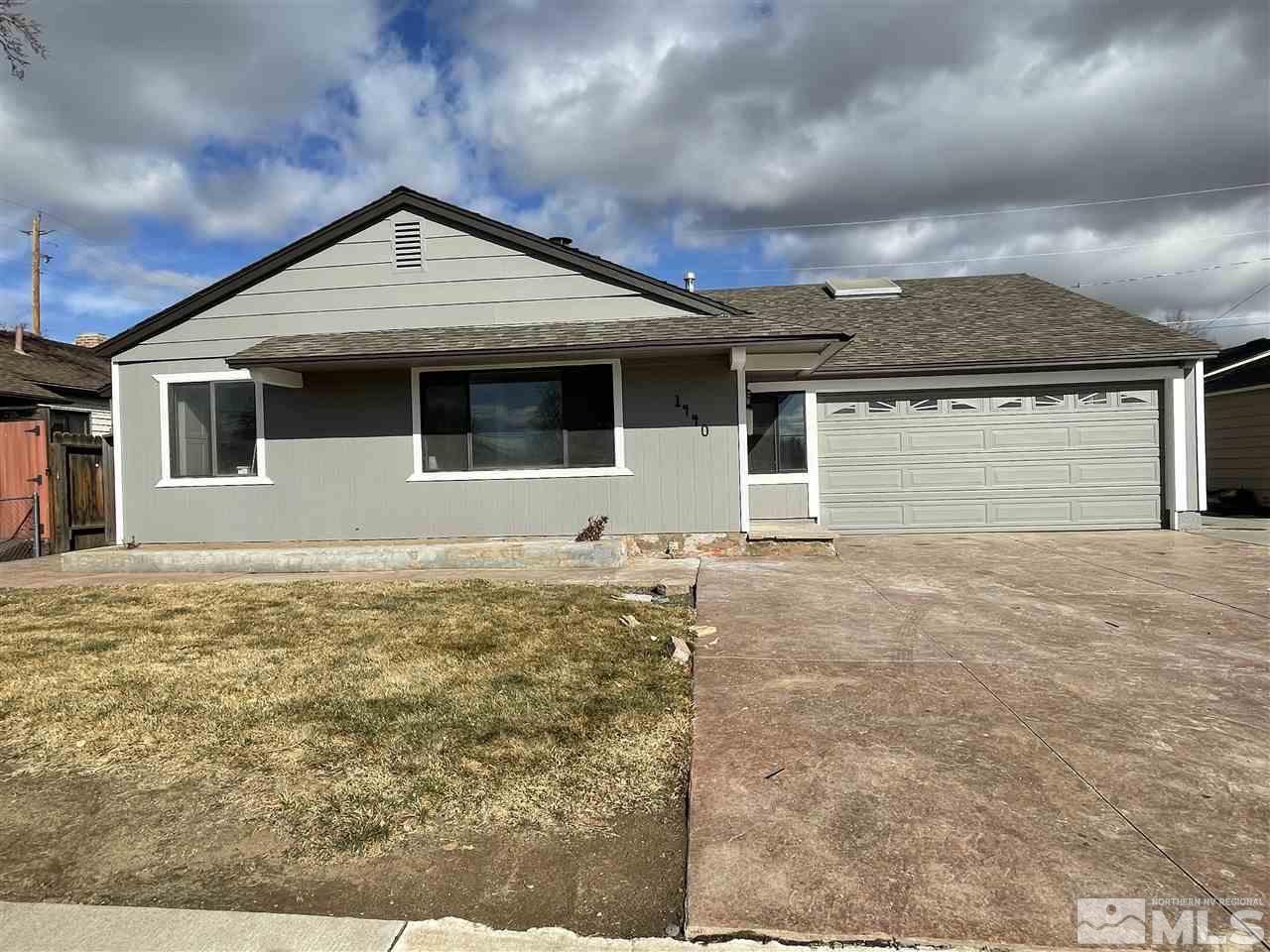 1440 Upton Way Sparks, NV 89431 - Photo 27 of 28 a front view of a house with a yard