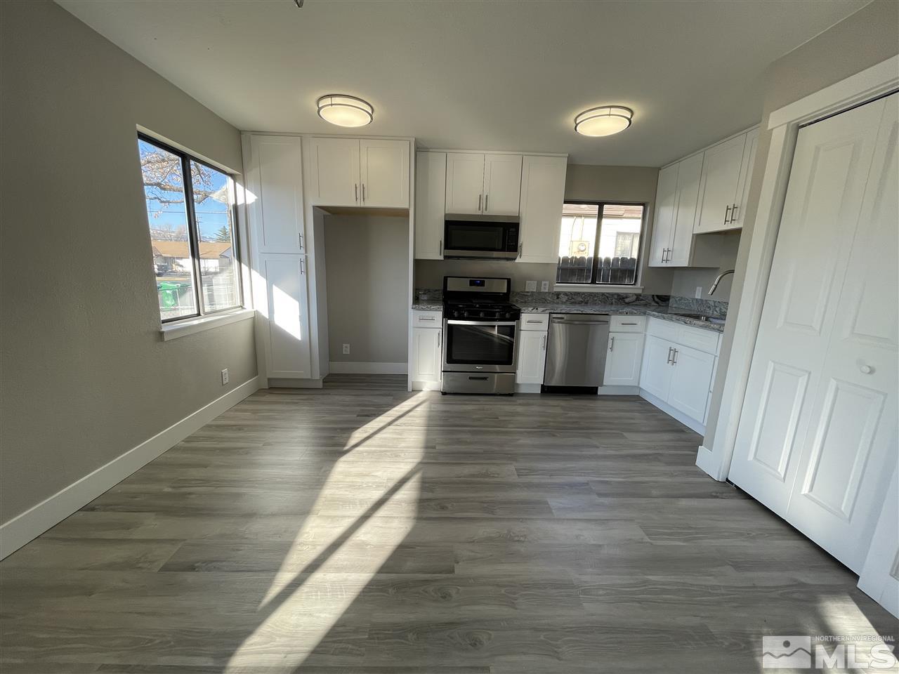 1440 Upton Way Sparks, NV 89431 - Photo 5 of 28 a large kitchen with cabinets wooden floor and stainless steel appliances