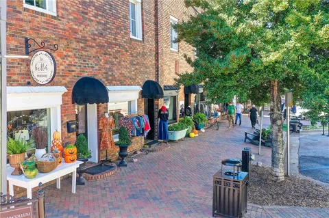 a front view of a building with outdoor seating