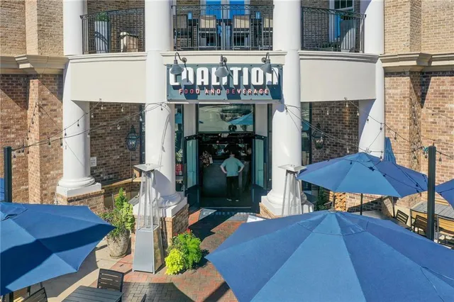 a view of a patio with table and chairs with wooden floor and fence