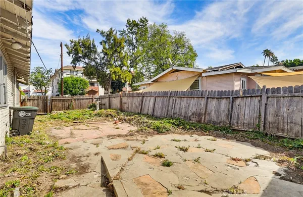 a view of a backyard with a tree