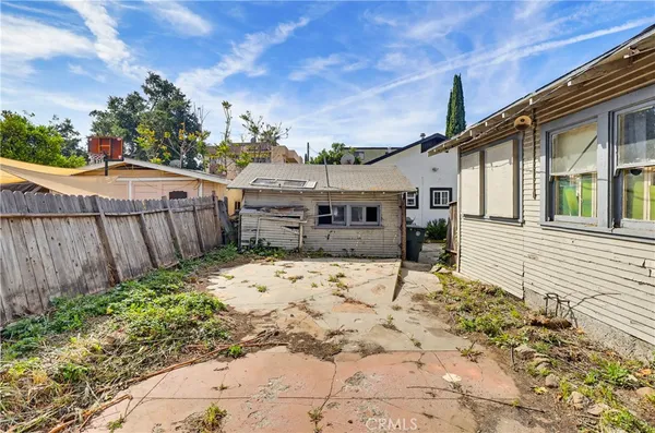 a view of a house with a wooden fence
