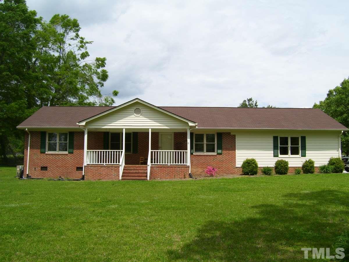 213 Red Mountain Road Rougemont, NC 27572 - Photo 1 of 18 a front view of a house with a yard and green space