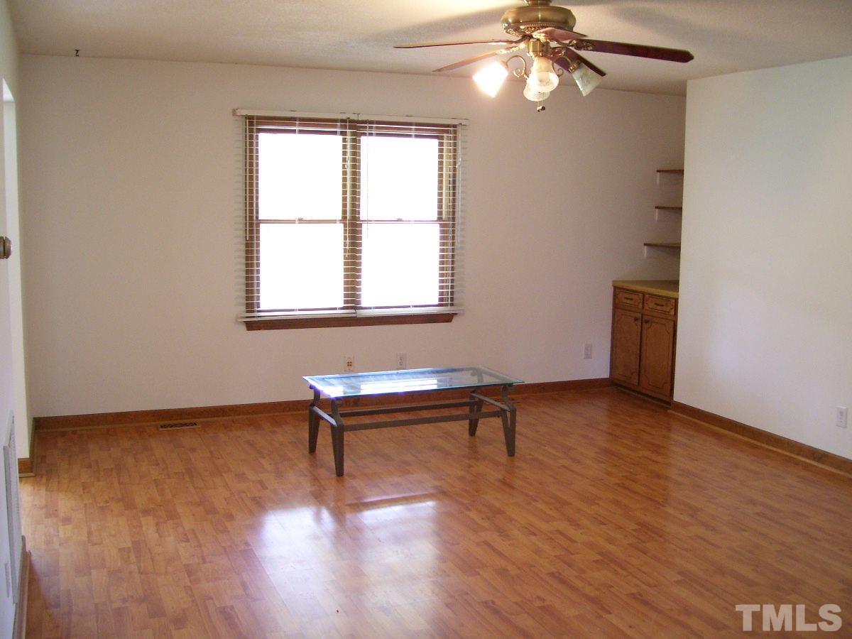213 Red Mountain Road Rougemont, NC 27572 - Photo 3 of 18 a view of empty room with wooden floor and fan