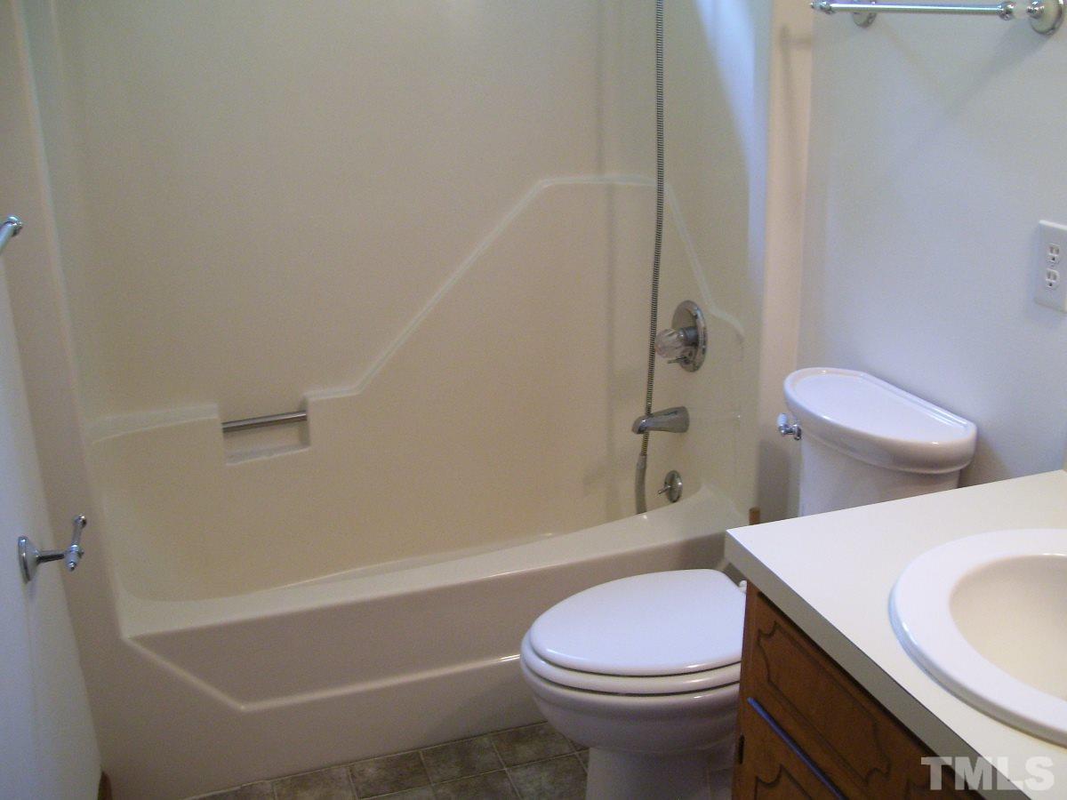 213 Red Mountain Road Rougemont, NC 27572 - Photo 6 of 18 a white toilet sitting next to a bath tub