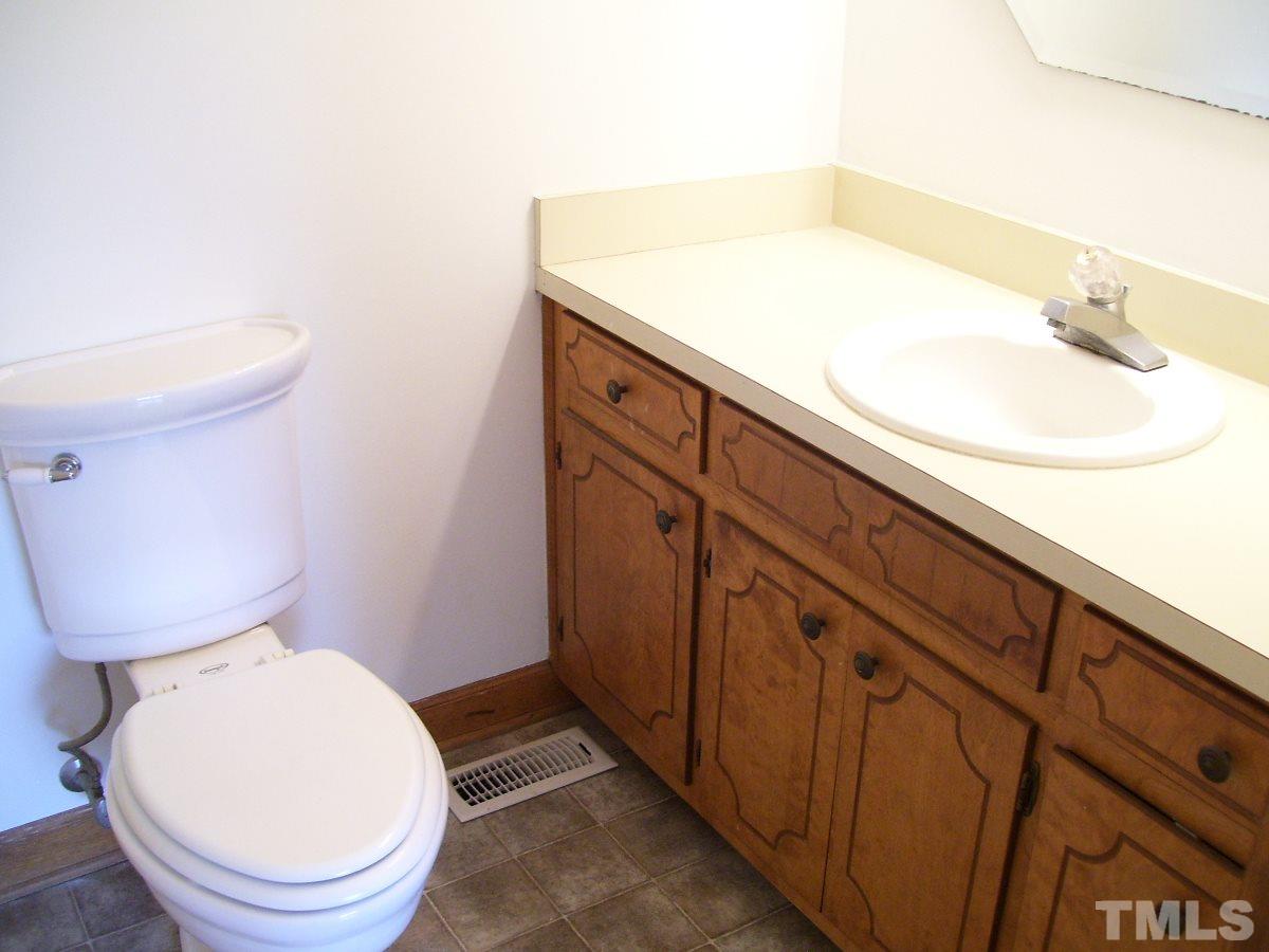 213 Red Mountain Road Rougemont, NC 27572 - Photo 8 of 18 a bathroom with a sink mirror vanity and toilet