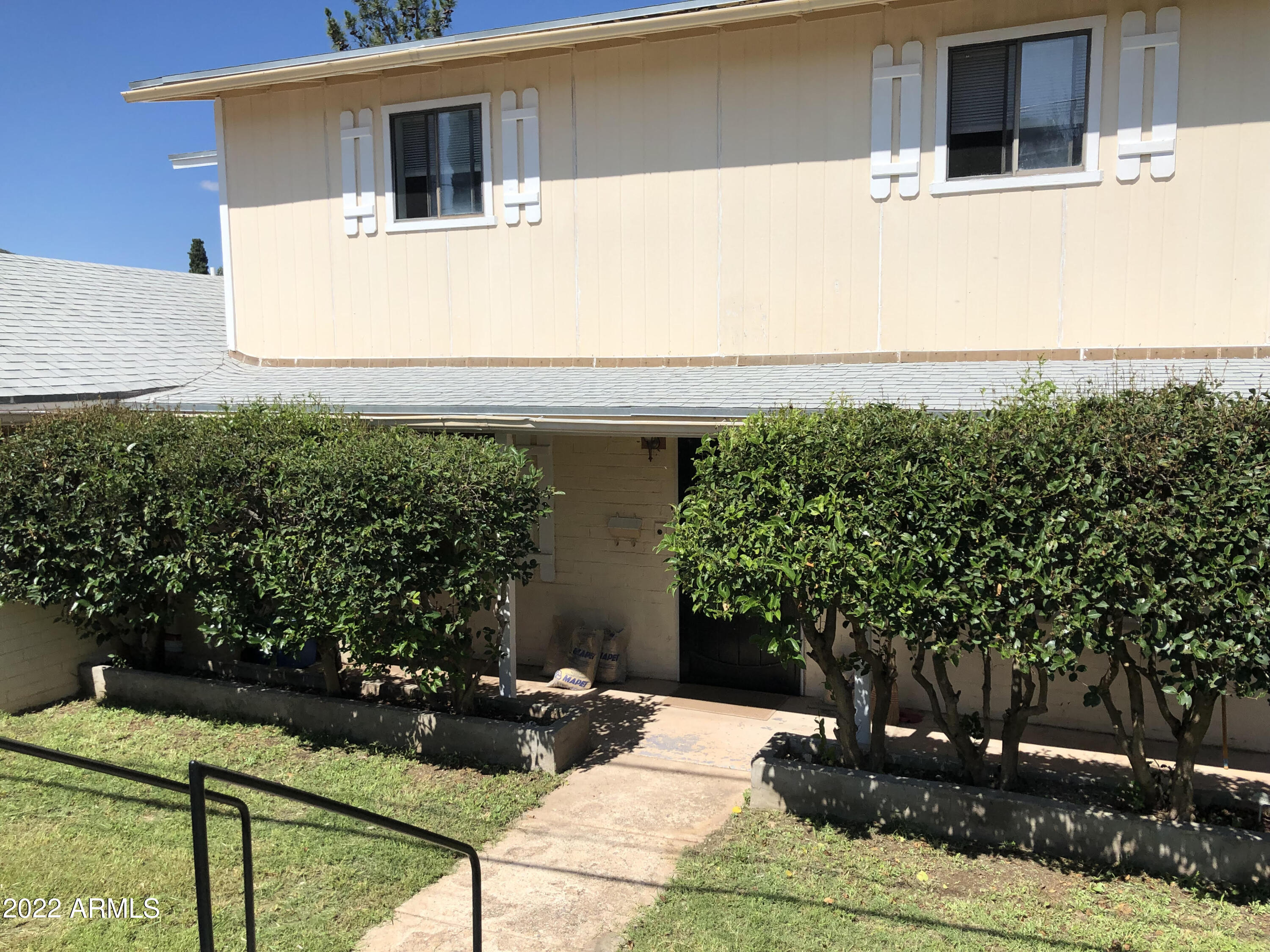 511 Mance Street Bisbee, AZ 85603 - Photo 3 of 22 a front view of a house with garden