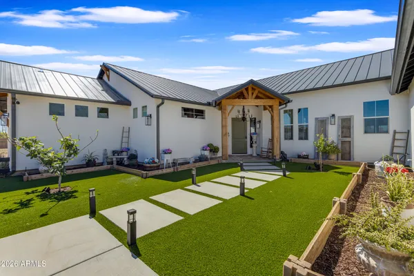 a large kitchen with stainless steel appliances a stove center island a dining table and chairs with wooden floor