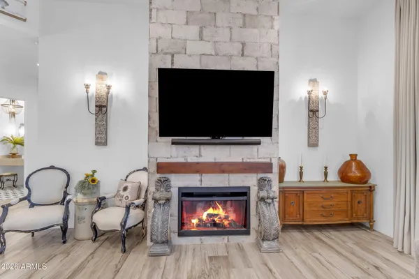 a spacious bedroom with a bed and glass walk in closet