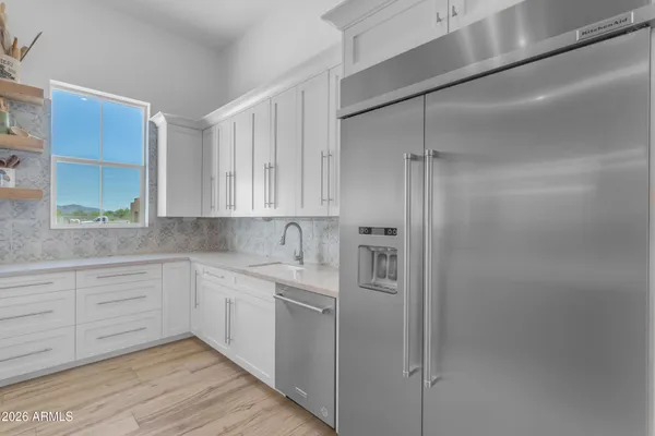 a spacious en suite bathroom with a granite countertop tub and a large window