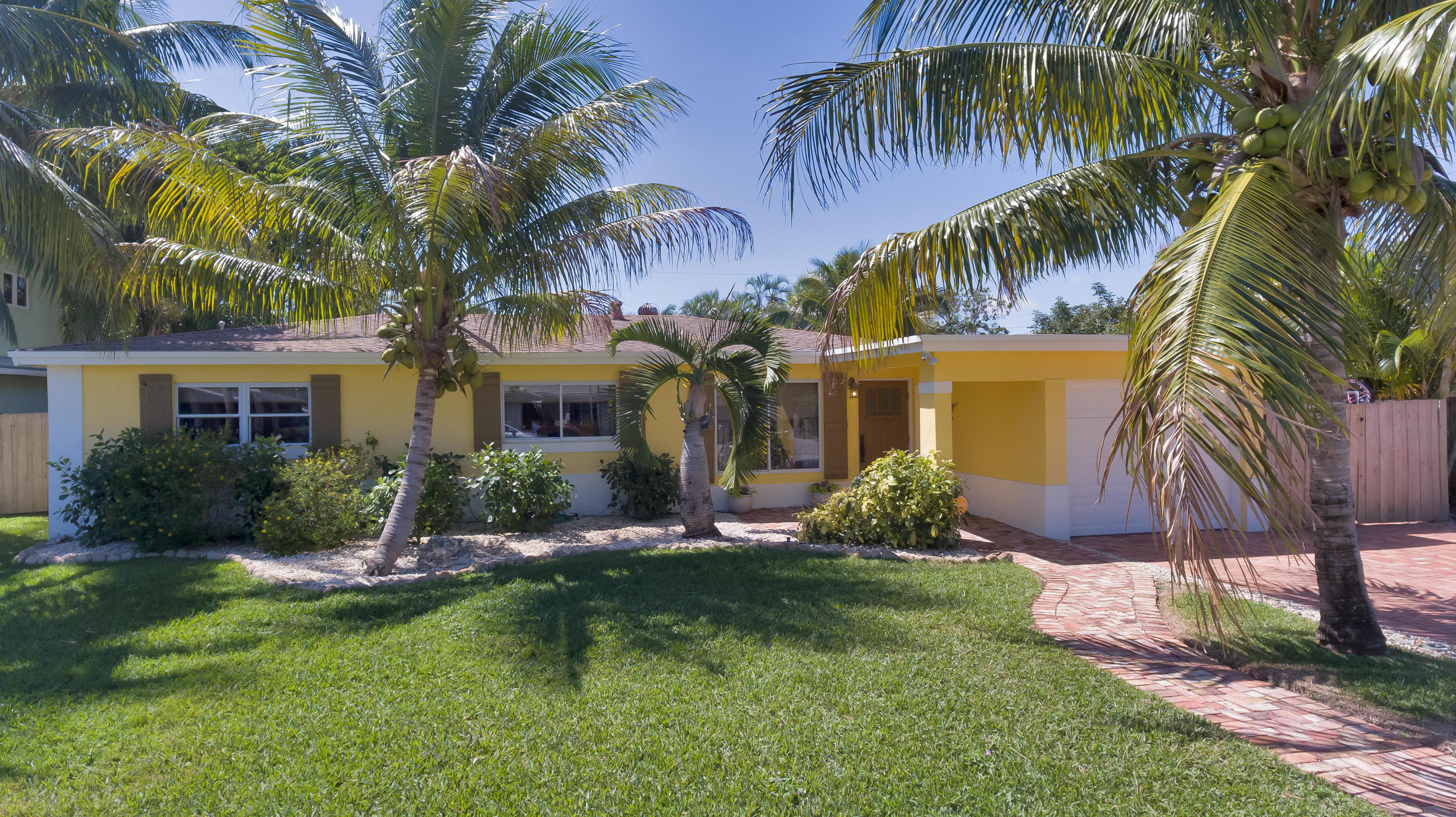 334 Northeast 28th Road Boca Raton, FL 33431 - Photo 26 of 32 a front view of house with yard and green space