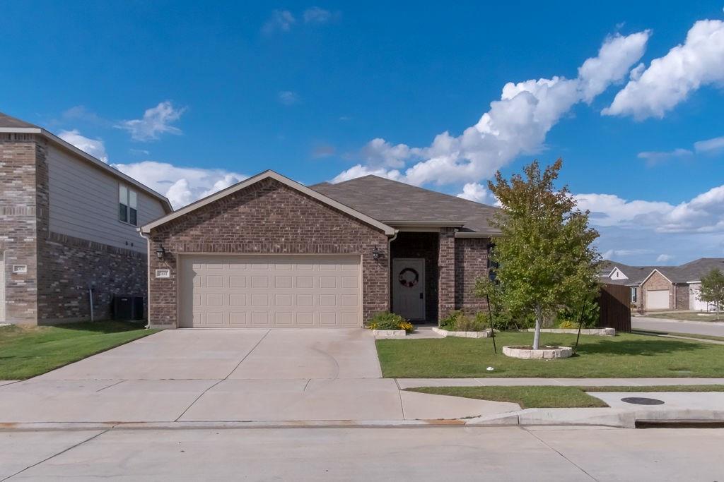 2441 Simmental Road Fort Worth, TX 76131 - Photo 1 of 1 a front view of a house with a yard and garage