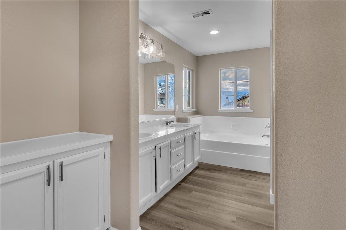 1218 Carmelo Soledad, CA 93960 - Photo 13 of 43 a bathroom with a double vanity sink a mirror and a bathtub