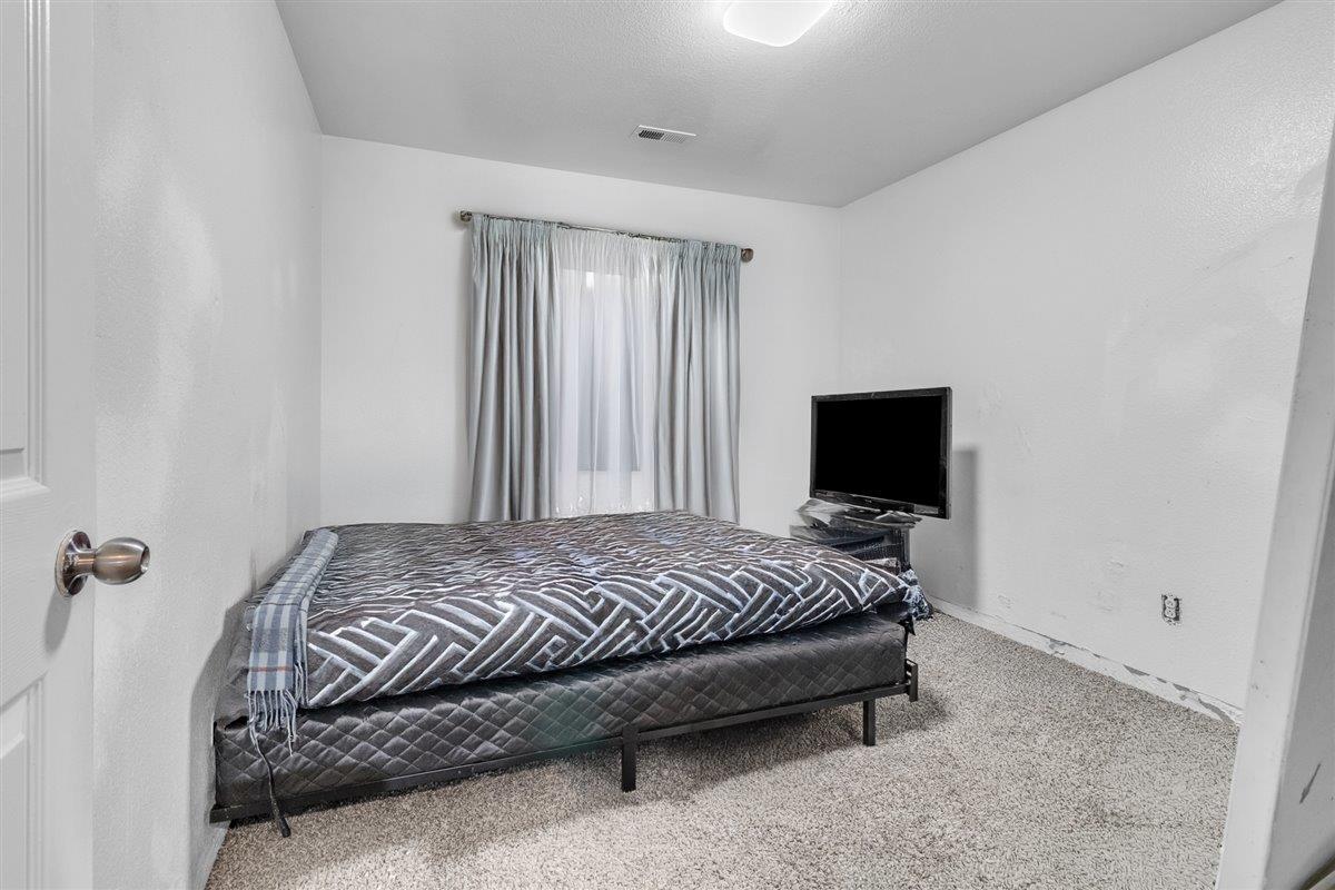 1218 Carmelo Soledad, CA 93960 - Photo 18 of 43 a bedroom with a bed and a flat screen tv