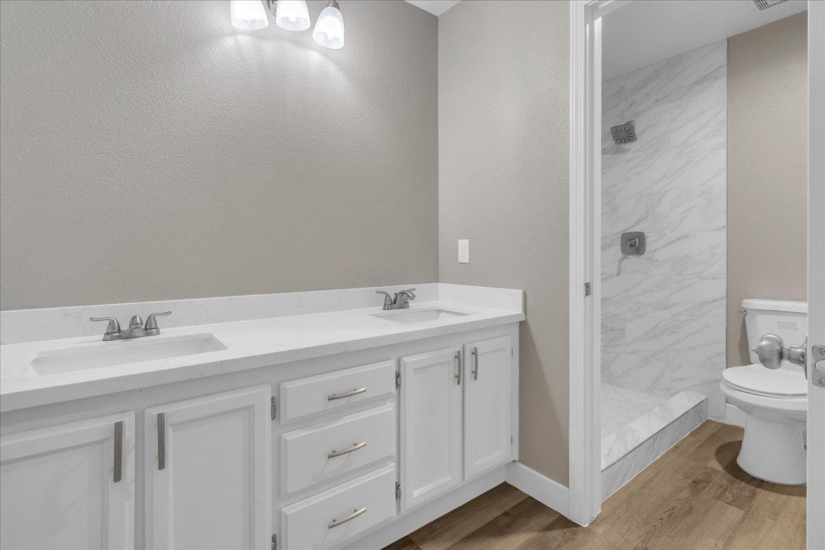 1218 Carmelo Soledad, CA 93960 - Photo 19 of 43 a bathroom with a sink a toilet and shower