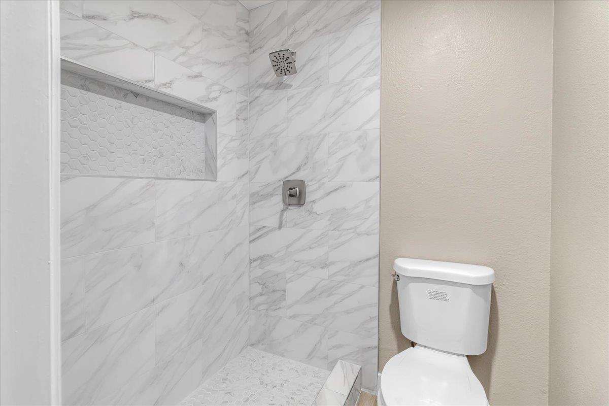 1218 Carmelo Soledad, CA 93960 - Photo 20 of 43 a white toilet sitting next to a shower