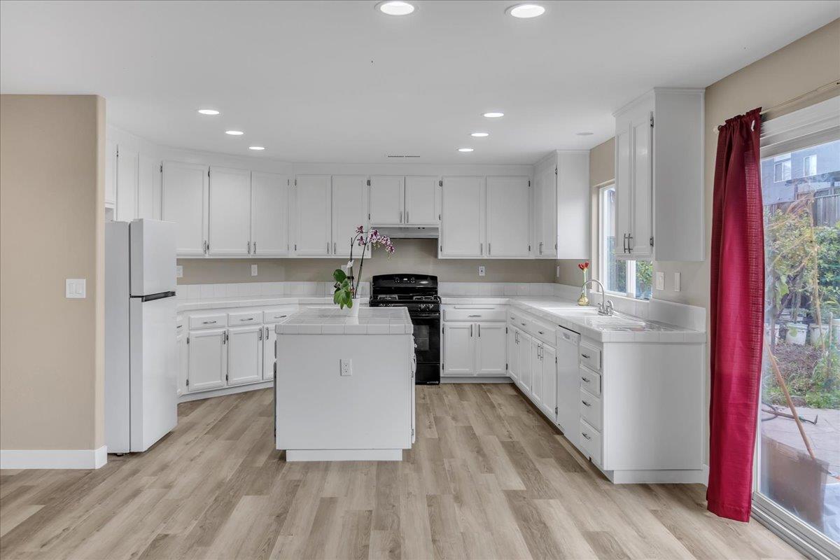 1218 Carmelo Soledad, CA 93960 - Photo 3 of 43 a kitchen with granite countertop a stove a sink and a refrigerator