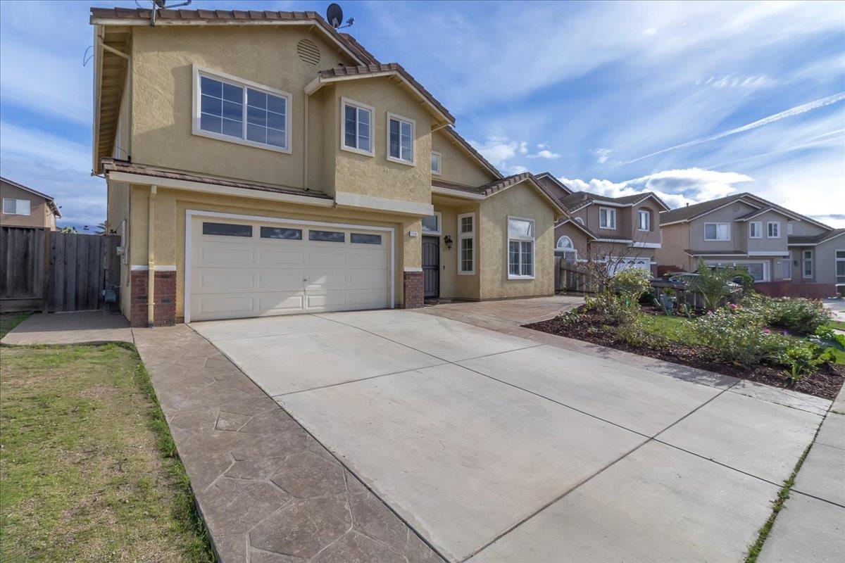 1218 Carmelo Soledad, CA 93960 - Photo 31 of 43 a front view of a house with a yard and garage