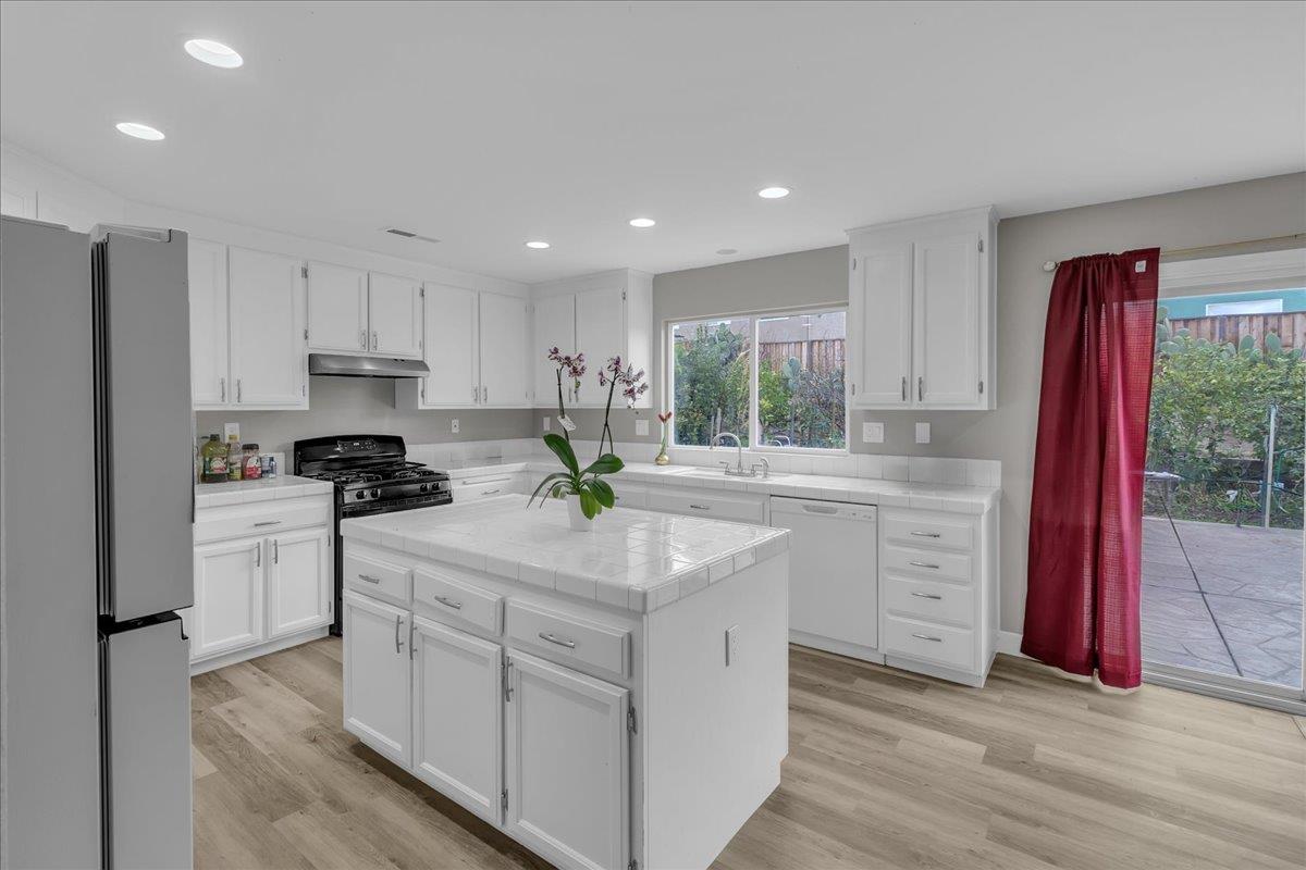 1218 Carmelo Soledad, CA 93960 - Photo 4 of 43 a kitchen with granite countertop white cabinets and white appliances