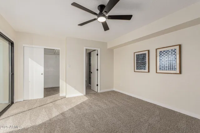 a view of a livingroom with a ceiling fan & a ceiling fan