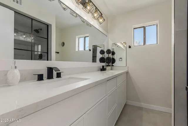 a bathroom with a sink and a mirror