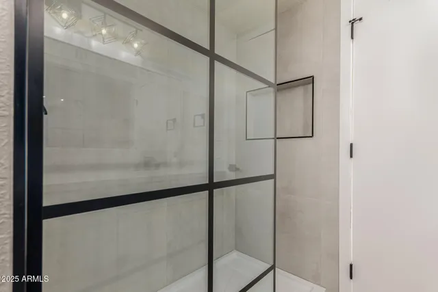 a bathroom with a glass shower door