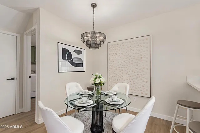 a view of a dining room with furniture wooden floor and a chandelier