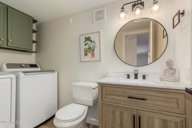 a bathroom with a toilet a sink and a mirror