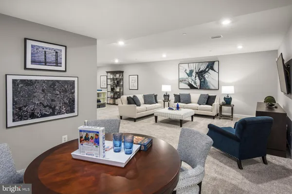 a living room with furniture and painting on the wall
