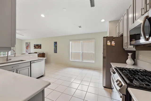 a kitchen with a sink stainless steel appliances and cabinets