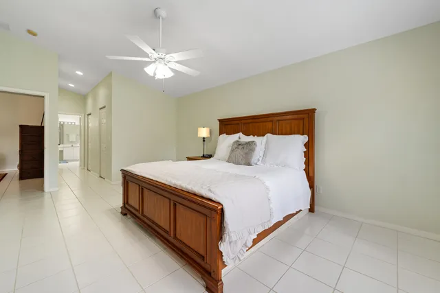a spacious bedroom with a bed and a chandelier