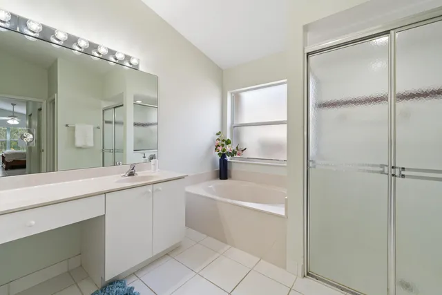 a bathroom with a tub sink and mirror