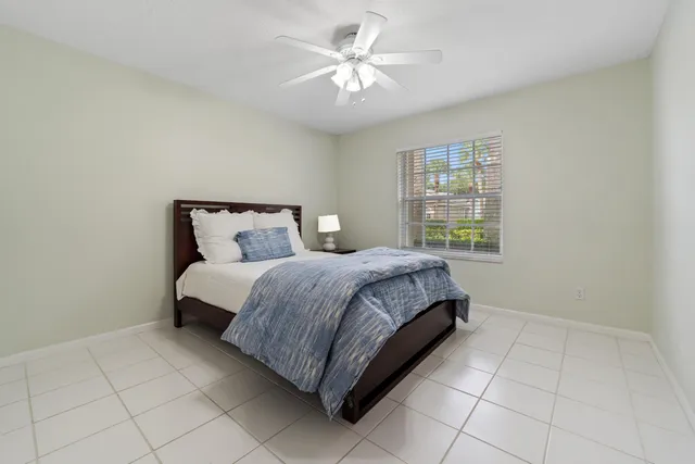 a bedroom with a bed and a ceiling fan