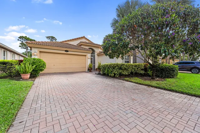 a front view of a house with a yard and a garage