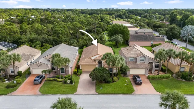 an aerial view of a house with garden space and street view