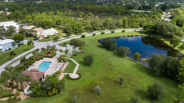 an aerial view of residential houses with outdoor space and lake view