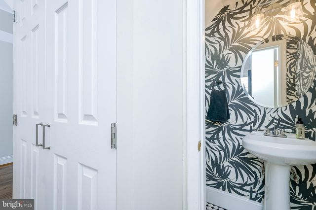 a dining room with furniture a chandelier and wooden floor