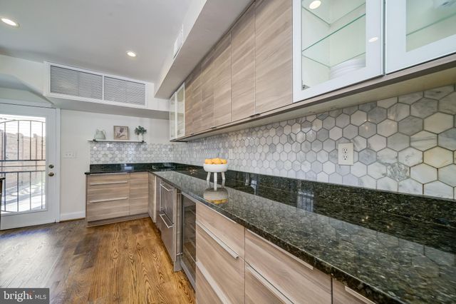 a kitchen with a stove oven and sink