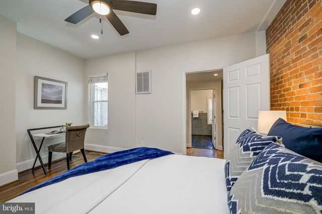 a bedroom with a bed and a table in it