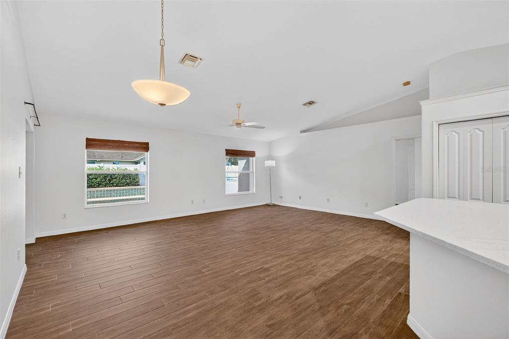 2113 Wolf Ridge Lane Mount Dora, FL 32757 - Photo 12 of 49 a view of empty room with wooden floor and fan