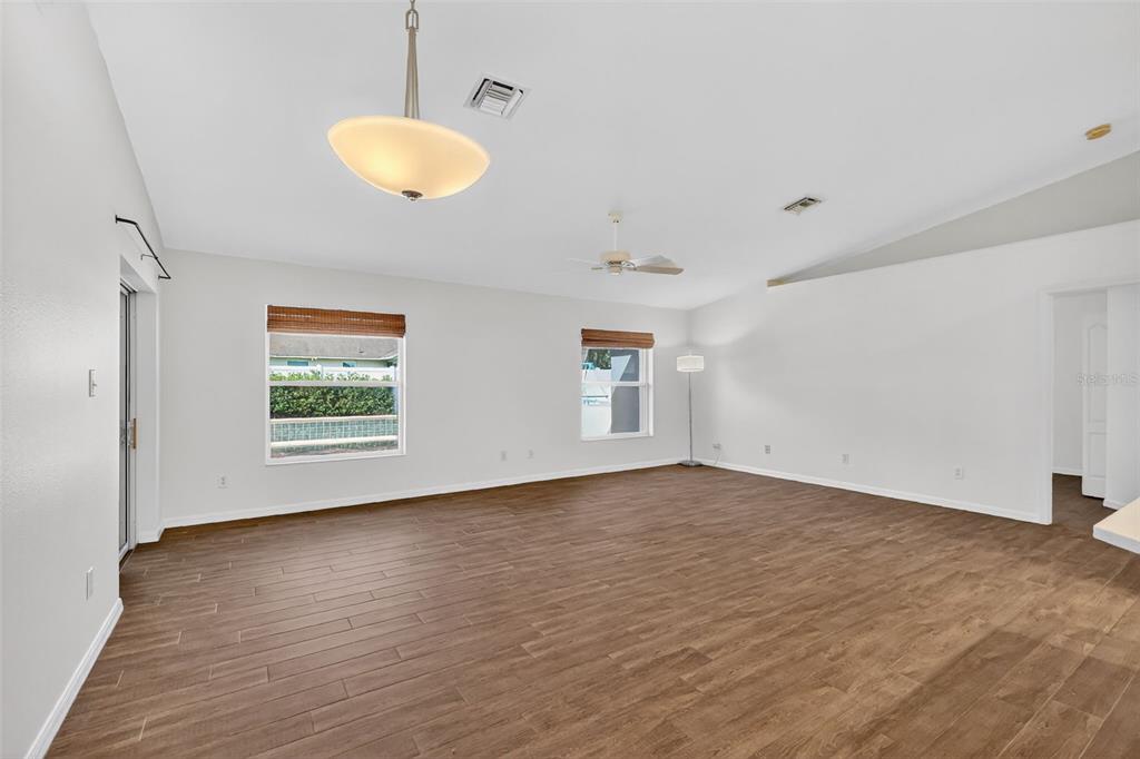 2113 Wolf Ridge Lane Mount Dora, FL 32757 - Photo 13 of 49 a view of an empty room with a window and wooden floor