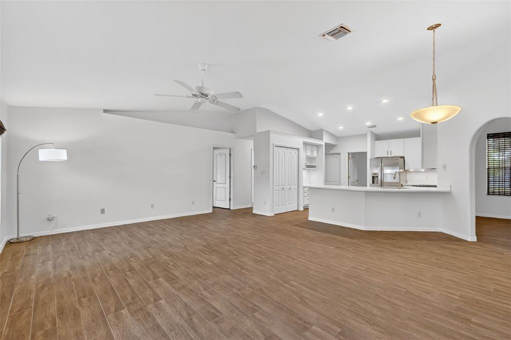 2113 Wolf Ridge Lane Mount Dora, FL 32757 - Photo 14 of 49 a view of an empty room with window and wooden floor