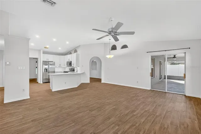 a view of a kitchen with wooden floor and a kitchen