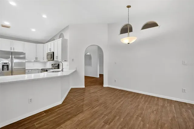 a view of a kitchen with a sink cabinets and wooden floor