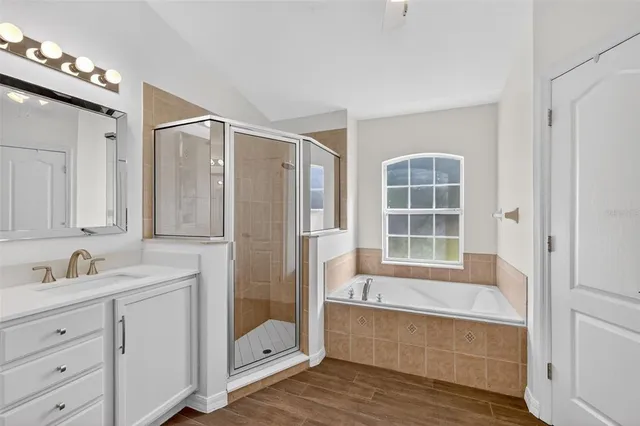 a bathroom with a tub shower and sink
